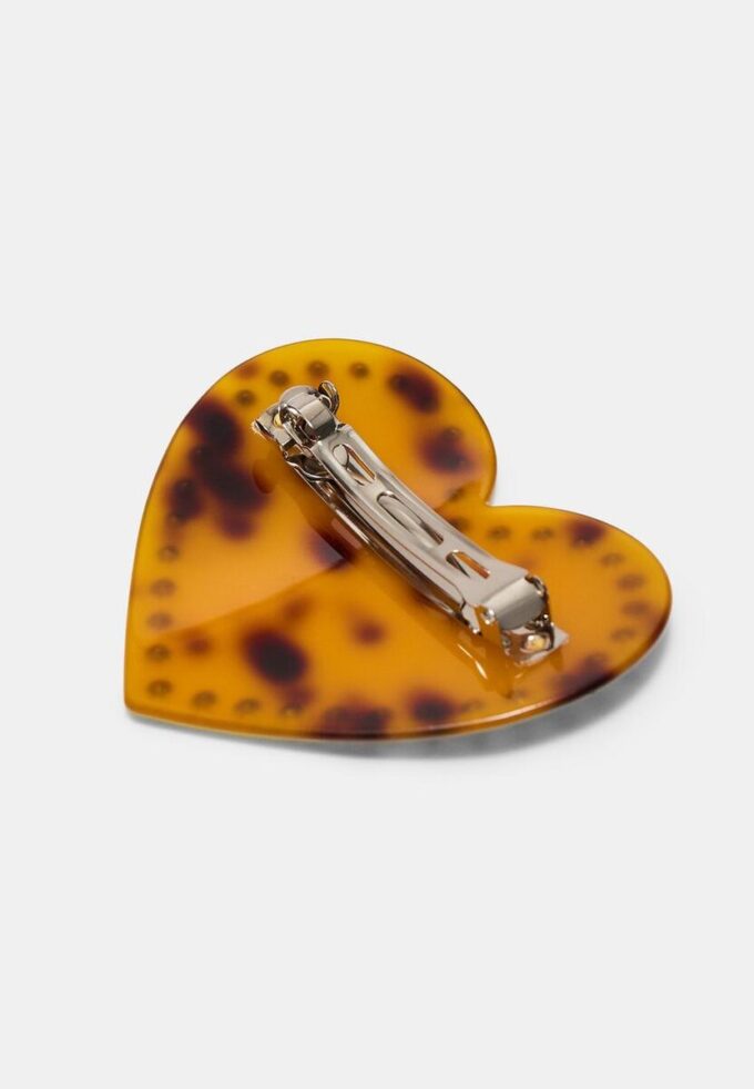 Broche de piel con tachuelas en forma de corazón