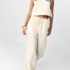 Pantalones con efecto lino y hilos metálicos fluidos Pantalones con efecto lino y hilos metálicos fluidos